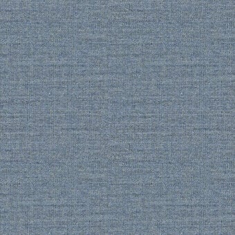 Woven fabric sample in blue-gray, exhibiting a dense, matte texture with subtle heathering and uniform weave; reference label present.